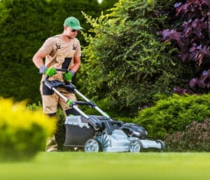 Technician overseeding in clay soil – Blue Duck Lawn Care Indiana